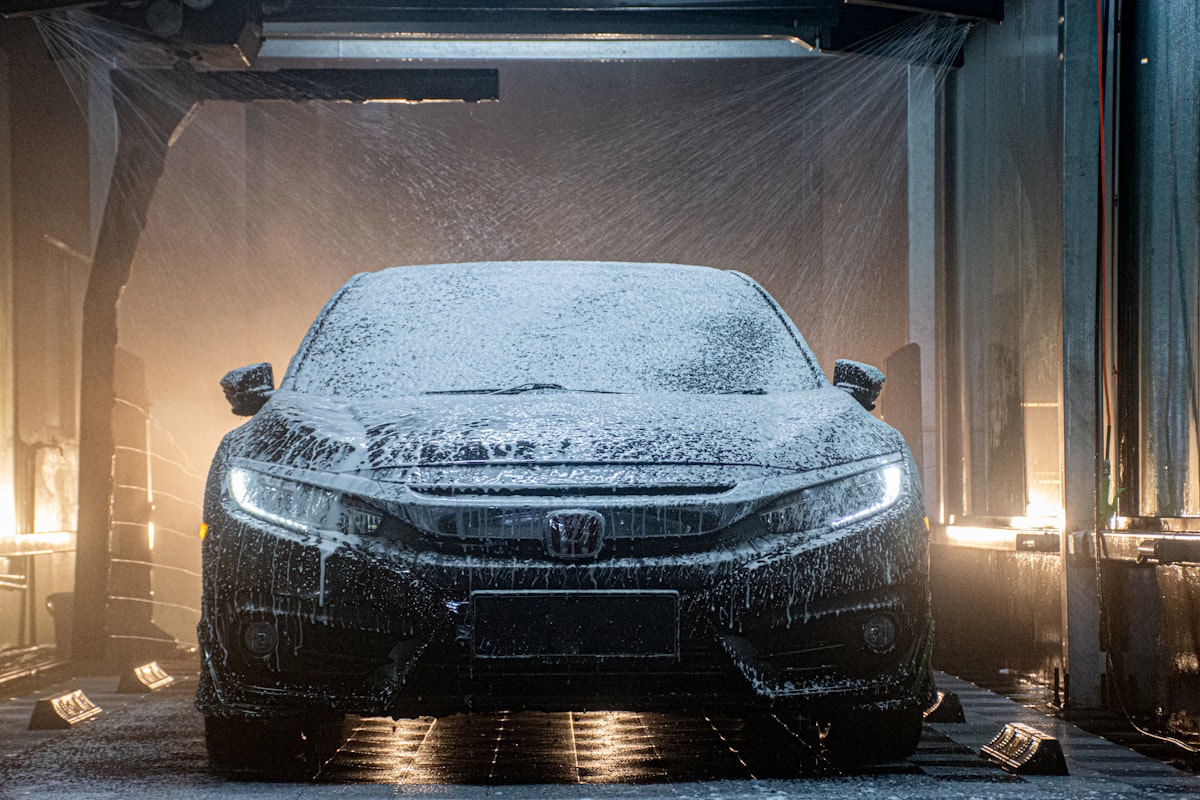Car covered in thick cleaning foam during a hand wash